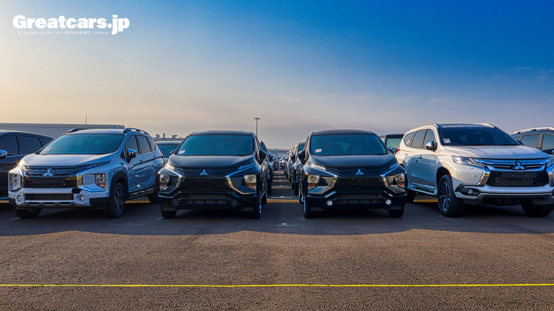 Japanese used cars lined up at an export terminal ready for international shipping.